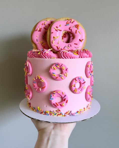 Donut day! But make it cake and cookies 🍩💖 • • Order desserts themed like other desserts on our website 🔗 in bio! • • #donutcake #donutparty #buttercreamcakes #buttercreamcake #buttercream #buttercreamart #customcake #cakedecorating #cakestagram #cakedesign #instacake #cakeideas #vermontbakery #vermontbaker #homebaker #homebakery #bakergram #vermont #madeinvermont #madeinvt #shelburnevermont #shelburnevt #bluehousebakeshop #cake #baker #pastrychef Donut Cake Decoration, Small Donut Cake, Pink Donut Cake, Donut Bday Cake, Donut Bday Party Ideas, Donut Grow Up Cake, Donut Birthday Party Cake, Birthday Donut Cake, Donut Theme Cake