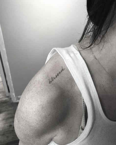 Meaningful word wrist tattoo Word Tattoos On Shoulder, Roo Tattoos, Trapezius Tattoo, Shoulder Tattoo Words, Small Word Tattoos, Tattoos On Shoulder, Blessed Tattoo, Small Words Tattoo, Short Quote Tattoos