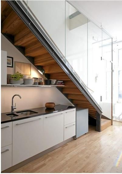 When space is tight, a clever strategy is to annex the area under a staircase. Here's a roundup of kitchens that maximize below-stairs space. Small Space Stairs, Kitchen Under Stairs, Space Under Stairs, تحت الدرج, Organiser Cucina, Stairs In Kitchen, Kitchen Storage Units, Kitchen Design Small Space, Kabinet Dapur