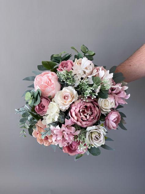 "Dusty rose bridal wedding bouquet is created with high quality silk flowers. These handmade artificial wedding bouquets make beautiful additions to wedding and event floral arrangements. Flowers: peonies, roses, eucalyptus and fillers.  Colors: dusty rose, pink, pale pink, mauve, white, pale champagne, green. Handle: wrapped in ivory satin ribbon. Size: bridal bouquet is approximately 14\" wide, bridesmaids bouquet is 8\". SUGGESTION: steaming the bouquets, boutonnieres, corsages upon receiving Pink Artificial Wedding Bouquet, Mauve And Sage Wedding, Mauve And Pink Wedding, Bridal Bouquet Mauve, Bridal Bouquet Dusty Rose, Mauve Wedding Bouquet, Dusty Rose Bridal Bouquet, Dusty Rose Bouquet, Wedding Bouquet Pink