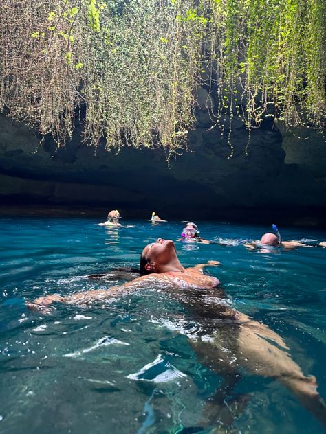 Girl floating in natural spring water in cave. Devils Den Florida Pictures, Snorkeling Aesthetic, Cave Photoshoot, Williston Florida, Snorkeling Pictures, Water Cave, Devils Den, Florida Pictures, Florida Aesthetic