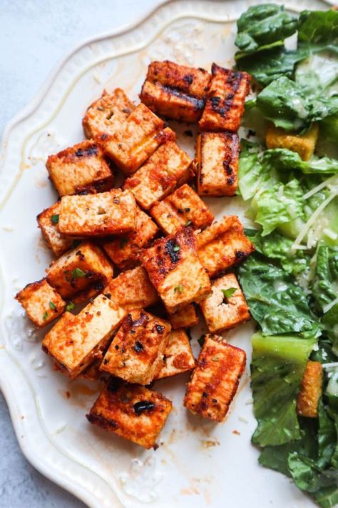 plate with grilled tofu seasoned with a greek marinade Greek Marinated Tofu, Mediterranean Tofu Marinade, Greek Tofu Bowl, Greek Tofu Recipes, Greek Tofu Marinade, Marinated Tofu Recipes, Greek Tofu, Mediterranean Tofu, Tofu Marinade Recipes