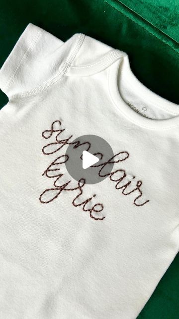 Knotty Bean Stitching Co • Hand-Embroidered Goods on Instagram: "Over 200 stitches & 2.5 hours later… the making of a back-stitched baby name onesie 🤎 Onesies are an unforgiving medium for embroidery, so I have to take extra time to ensure that the stitches lay well and don’t cause any pulls in the plane of the fabric 🪡 I stitched this onesie with “cocoa” floss and I love how it looks with this elegant script! #embroideryhoop #embroideredname #babyname #personalizedonesie #babynameonesie #customembroidery #learnembroidery #embroidereverything #modernembroidery" Hand Embroidered Name Onesie, Embroidered Baby Onesie, Baby Onesie Embroidery, Hand Embroidered Onesie, Onesie Embroidery, Baby Name Onesie, 5 Hours Later, Name Onesie, In The Plane