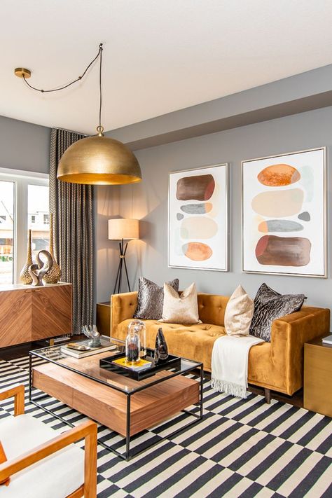 Brightly decorated living room. Pop Of Orange Living Room, Pop Of Colour In Grey Living Room, Orange Sofa Living Room Ideas Modern, Ginger Couch Living Room, Gold Couch Living Room Color Palettes, Burnt Orange Couch Living Room, Orange And Grey Living Room Decor, Orange Couch Living Room Ideas, Orange Couch Living Room