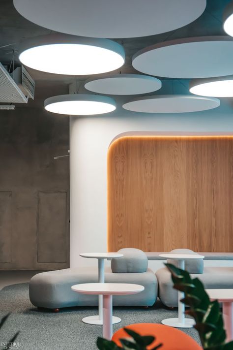 Circular lighting and sound-absorbing panels line the ceiling above an informal conversational zone. In central Almaty, Kazakhstan's largest metropolis and cultural hub, Damir Ussenov and his team at Lenz Architects created a futuristic co-working space for an IT company that combines bold colors and solid concrete with pure minimalism and curved shapes. #InteriorDeisgn #OfficeDesign #ModernOffice Coffee Shop Concept, Office Ceiling, Almaty Kazakhstan, Circular Lighting, Co Working Space, Futuristic Interior, Workspace Design, Interior Design Magazine, Salou