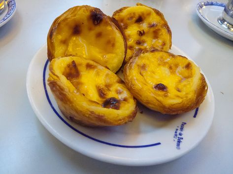 Pastéis de Nata: Authentic Portuguese Custard Tarts Recipe – Devour Tours Affordable Places To Travel, Portuguese Custard Tart Recipe, Natas Recipe, Portuguese Custard Tarts, Bologna Food, Portuguese Tarts, Portuguese Dessert Recipes, Custard Tarts Recipe, Portuguese Egg Tart