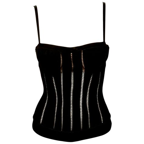 Black knit corset top with decorative stitching and attached padded push-up bra designed by Azzedine Alaia dating exactly as seen on the fall 1991 runway and countless editorials. Labeled a Size 'S' and best fits an XS or S. Made in Italy. Center back brass zipper. Fabric content: 90% viscose, 6% nylon, 4% spandex. Excellent condition. Corset Runway, Alaia Mini, Korsett Top, Knit Corset, Runway Top, Corset Top Black, Vintage Bustier, Azzedine Alaïa, Black Corset Top