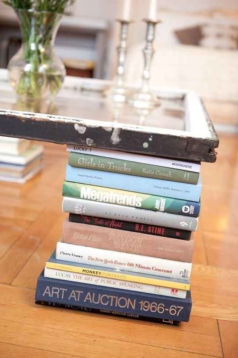 Get crafty and make your own coffee table with book legs | 30 Totally Unique Ways To Decorate Your Home With Books Cheap Coffee Table, Make Your Own Coffee, Book Page Wreath, Old Book Crafts, Cheap Coffee, Book Table, Apartment Diy, Diy Coffee Table, Old Frames