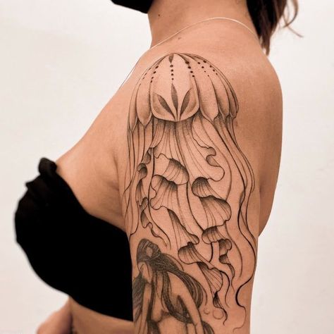 Discover the art of transformation with jellyfish tattoos in our article. Explore it and find 50+ stylish designs with meanings explained. Jellyfish Tattoo Arm Sleeve, Realistic Jelly Fish Tattoo, Jellyfish Arm Tattoos For Women, Shoulder Jellyfish Tattoo, Jellyfish Tattoo Meaning, Jellyfish Shoulder Tattoo, Sea Nettle Jellyfish Tattoo, Transformation Tattoo, Medusa Animal