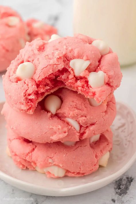 A stack of strawberry cookies with a bite taken from the top one. Strawberry Gooey Butter Cookies, Strawberry Blossom Cookies, 3 Ingredient Strawberry Cookies, Strawberry Cake Cookies Mix Boxes, How To Make Strawberry Cookies, Strawberry Box Cake Cookies, Strawberry Milkshake Cookies, Strawberry Cookie Bars, Strawberry Cake Cookies Recipe