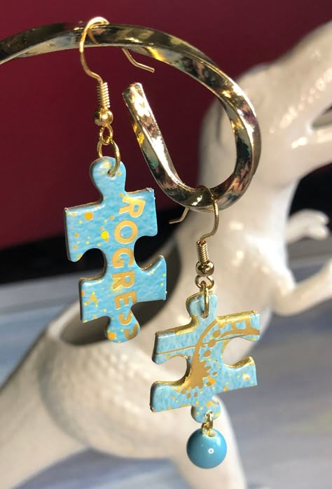 These handmade puzzle piece earrings are one of a kind.  They are asymmetrical with one featuring a turquoise dangling bauble. They are a quirky addition to a casual wardrobe or a splash of fun and sparkle with something more dressy. Art With Puzzle Pieces, Unique Upcycled Jewelry For Gifts, Unique Upcycled Jewelry As A Gift, Unique Upcycled Jewelry Gift, Unique Diy Earrings Ideas, Colorful Handmade Funky Earrings, Puzzle Piece Jewelry, Fun Earrings Unique, Quirky Multicolor Handmade Earrings