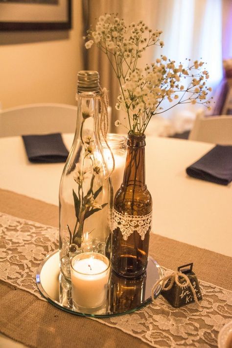 Wine bottle vases sitting atop of a round mirror with votive candle rests on a burlap & lace table runner, complete with a bell to "ring for a kiss." Wine Centerpieces, Wine Decorations, 39 Birthday, Spring Soiree, Wine Bottle Vases, Wine Bottle Centerpieces, Wedding Wine Bottles, Bottle Centerpieces, Wedding Bottles