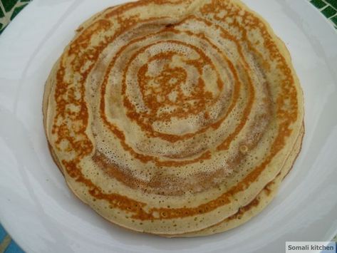 Malawah is a plate sized sweet pancake that is perfect for breakfast or as snack anytime during the day. While there are slight variations in how Somalis make this pancake, this particular recipe with its fragrant touch of cardamom is how I like my malawah. I love eating malawah with... Malawah Somali, Somalian Recipes, Somali Breakfast, Mali Food, Somali Recipes, Somalian Food, Somali Recipe, Somali Food, Ethiopian Recipes