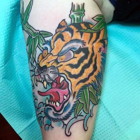 Old School Roaring Japanese Tiger With Bamboo And Ocean Waves Tattoo For Guys Tiger Bamboo Tattoo, Tiger Knee Tattoo, Mens Tiger Tattoo, Belfast Tattoo, Traditional Tiger Tattoo, Tattoo Catalog, Bamboo Tattoo, Worlds Best Tattoos, Cool Tattoos For Guys