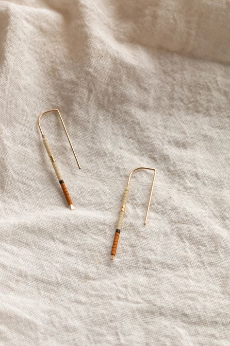 The 'Mala' Ear Pins (meaning 'To complete' in Tumbuka). Inspired by a balanced palette of earthen hues accented with charcoal and gold details, the sweet Mala Ear Pins are made from 14k gold-fill wire & Japanese glass beads, perfect for the everyday minimalist. Beach Jewelry Boho, Ear Pins, Skill Training, Jewelry Inspo, Fashion Help, Gold Details, Minimalist Jewelry, Wholesale Jewelry, The Sweet