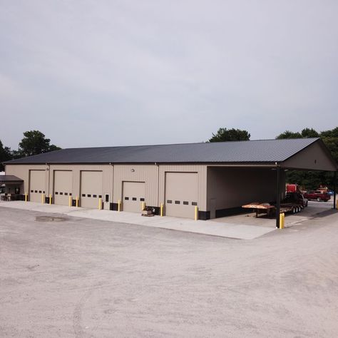 We built Vaughan's Diesel Repair a new equipment shop measuring 81' x 148' x 18' with our beige steel panels and black trim. The project features 5 drive-thru work bays for the diesel trucks. The project includes insulation throughout the building with our steel liner package. 

The building includes bathrooms, a plastic lined wash bay, a parts bay and additional storage with an exposed bay on the side of the building. The main entrance features a gabled roof porch measuring 16' x 12'. Farm Office Building, Barn Shop The Home Depot, Pole Barn For Boat Storage, Gray Pole Barn With Black Doors, Pole Barn Mechanic Shop, Metal Shop Building 40x60 Pole Barn, Work Shop Building, Prefab Garages, Metal Shop Building