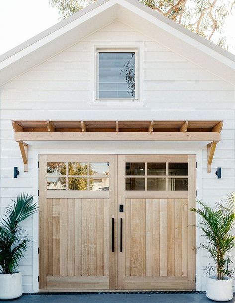 If you're a farmhouse enthusiast, there's no doubt that you've perfected your interiors with the ideal shade of white on the walls, tons of flea market finds, and a cozy feel that would make Joanna Gaines want to settle right in. Here are eight farmhouse garage door ideas to help you nail that country look we all love and adore. #hunkerhome #farmhouse #farmhousedecor #farmhousegarage #garageideas Farmhouse Garage Doors, Loughlin Furniture, Fabric Architecture, Backyard Barn, Farmhouse Garage, Bedding Master, Cosy House, Garage Door Design, Barn Garage