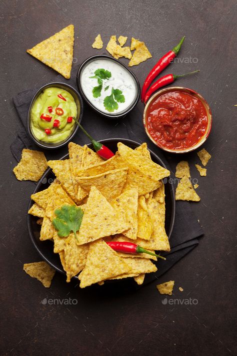 Mexican nachos chips and sauces by karandaev. Mexican nachos chips with various sauces â€?20guacamole, salsa and sour cream. Top view flat lay on stone table #AD #karandaev, #guacamole, #salsa, #sauces Nachos Chips, Mexican Nachos, Guacamole Salsa, Nacho Chips, Salsa Sauce, Stone Table, Born To Be Wild, Cheesy Sauce, Food Backgrounds