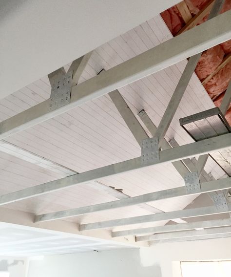 Want exposed beams in your house? Here's how... Exposed Header Beam, Corigated Metal Ceiling, Boards On Ceiling, Open Truss Ceiling, Exposed Ceiling Joists, Truss Ceiling, Ceiling Remodel, Exposed Ceiling, Exposed Trusses