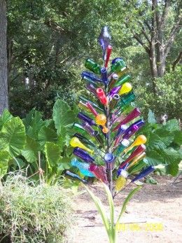 I had no idea bottle trees supposedly kept out evil spirits :) Better start saving some bottles. Wine Bottle Trees, Bottle Trees, Pallet Patio, Bottle Tree, Wine Bottle Art, Bottle Garden, Wine Bottle Diy Crafts, Glass Garden Art, Wine Bottle Diy