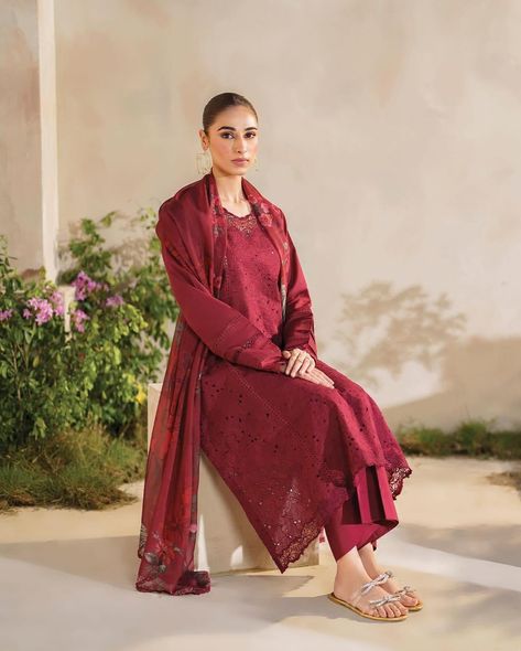 Radiant in Maroon: This ensemble exudes opulence with its intricate embroidery and luxurious textures. The borer embroidered lawn on the front paired with dyed lawn on the back and sleeves creates a harmonious balance of detail and elegance. Embroidered organza neckline and lace accents add a touch of sophistication, while the printed silk dupatta and dyed cambric trousers complete the look. 𝑭𝒆𝒔𝒕𝒊𝒗𝒆 𝑳𝒂𝒘𝒏 by Iznik – 𝑪𝒐𝒎𝒊𝒏𝒈 𝒔𝒐𝒐𝒏 to shop at #VogueClothingStudio #VogueFormals - all you add is or... Saira Shakira, Lawn Design, Embroidered Organza, Luxury Wear, Dresses Chiffon, Silk Dupatta, Fabric Stores Online, Printed Silk, Shakira