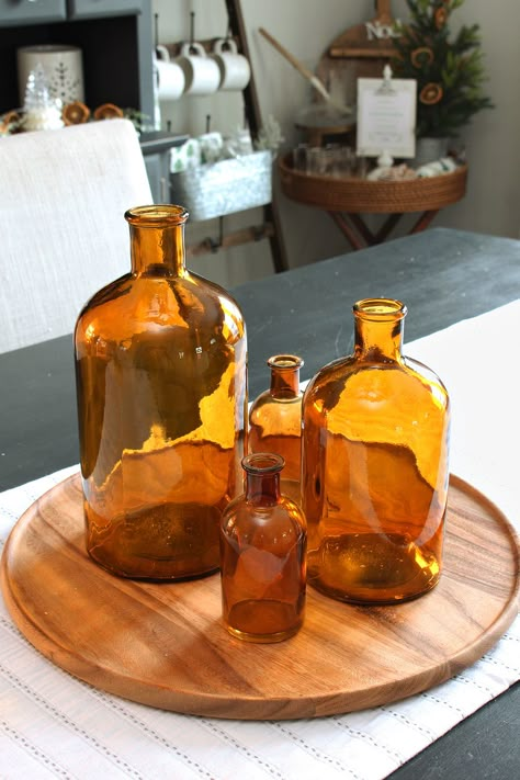 Amber Jar Centerpiece, Amber Bottles Decor, Amber Glass Christmas, Amber Glass Decor, Amber Vases, Glass Bottle Centerpieces, Diy Christmas Centerpiece, Diy Canvas Frame, Hunter Wedding