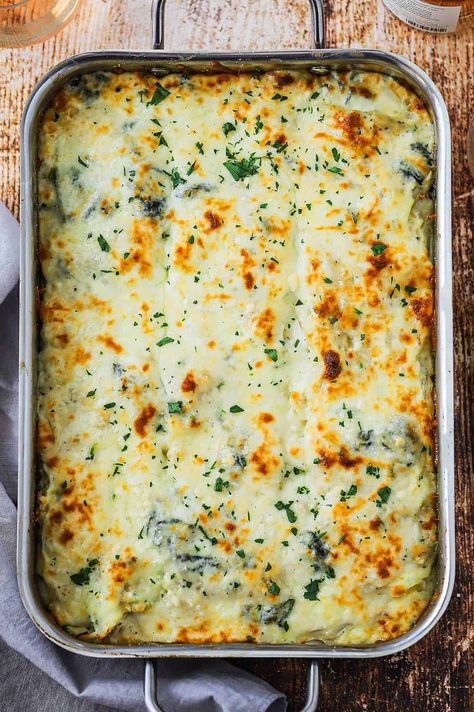 An overhead view of white chicken lasagna with spinach that has been fully cooked and lightly browned on top. Lasagna With Chicken, White Lasagna Recipe, Chicken Spinach Mushroom, Lasagna With Spinach, Chicken Spinach Lasagna, Spinach Mushroom Lasagna, White Chicken Lasagna, Chicken Lasagna Recipe, White Lasagna