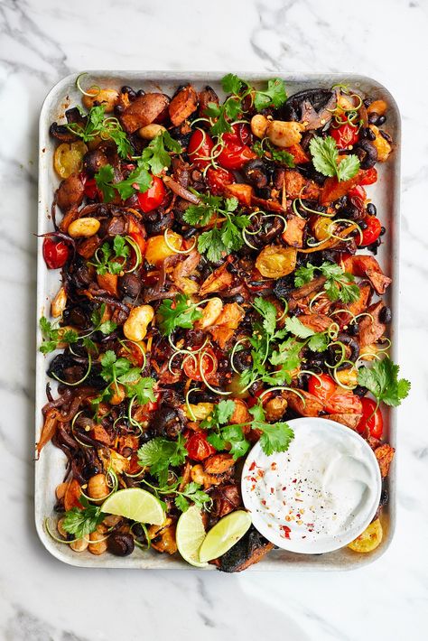 This sweet potato, mushroom and bean traybake is simple, full of amazing flavours, and so easy to bring together. The roasted garlic yoghurt makes a rich, creamy dressing for a traybake full of veggies and protein-rich beans seasoned with smoked paprika, oregano, tangy ginger and a little warm chilli kick. It also makes a super delicious lunch for the next day. Sweet Potato Mushroom, Potato Mushroom, Alkaline Recipes, Deliciously Ella, Creamy Dressing, Delicious Lunch, Midweek Meals, Roasted Squash, Dinner Food