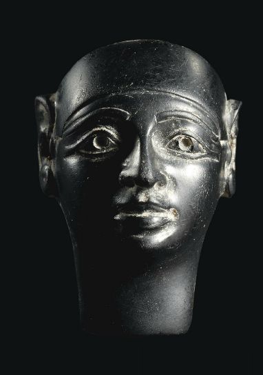 A PHOENICIAN BLACK OBSIDIAN HEAD OF A DIVINITY   CIRCA EARLY 1ST MILLENNIUM B.C.   Probably an inlay, in Egyptianising style, wearing a close-fitting cap, the face with full lips, aquiline nose, almond-shaped eyes with recessed pupils, finely delineated cosmetic lines and contoured eyebrows Bronze Age Civilization, Almond Shaped Eyes, Ancient Sculpture, Carthage, Ancient Egyptian Art, Black Obsidian, Egyptian Art, Ancient Artifacts, Ancient Civilizations