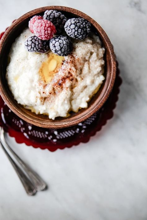 Risgrøt—a festive Norwegian rice pudding—is a heart-warming, soul-satisfying treat that is humble, almost too easy, and impossible not to love. How To Make Porridge, Breakfast Rice, The Modern Proper, Christmas Breakfast Recipe, Modern Proper, Porridge Recipes, Norwegian Food, Rice Porridge, Scandinavian Food