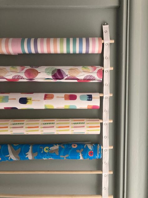 DIY Hanging Wrapping Paper Storage Solution Hanging Wrapping Paper Storage, Art Paper Storage, Storing Wrapping Paper, Diy Hanging Storage, Wrapping Closet, Home Depot Closet Organizer, Diy Wrapping Paper Storage, Store Wrapping Paper, Clutter Bug