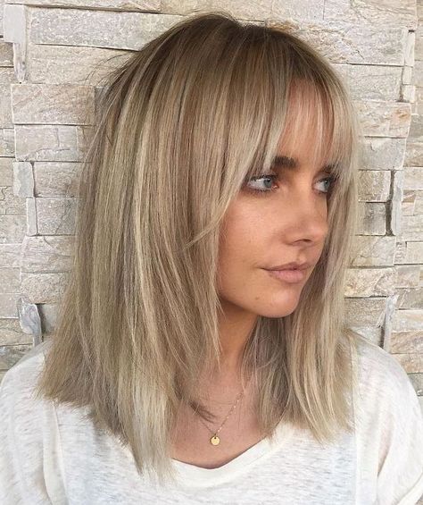 woman-with-blonde-hair-with-bangs-wearing-white-t-shirt-medium-length-layered-hair-brick-wall Wispy Bangs Lob, Blonde Lob With Bangs, Hairstyles With Fringe, Lob With Bangs, Shape Face, Blonde Lob, Medium Layered Hair, Smink Inspiration, Fringe Hairstyles