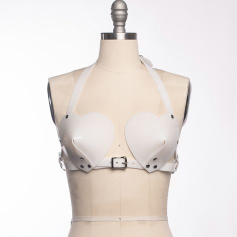 🖤🖤🖤 The Heart Bullet Bra, coming soon! 🖤🖤🖤 Shown here in milky white #pvc - same general design as the original harness bullet bra, but with cute #heartshaped cups. Some days it really feel like I have two designers fighting inside of me. One likes cute, pastel, rainbow colored sweet things. The other demands only an #allblackeverything witchy, goth aesthetic. Hopefully I'm not the only one with two moods 🥰 Don't worry - it will be available in black (and red... and pink!) too! . . . . . Fashion Harness, Leather Bra, Harness Bra, Bullet Bra, Retro Pin Up, Leather Lingerie, Leather Harness, Rose Gold Hardware, Cone Bra