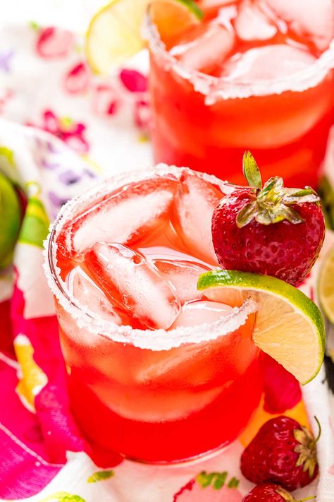 Strawberry Margaritas are fruity, fresh, and perfect for summer! Made with tequila, orange liqueur, fresh-squeezed lime juice, and homemade strawberry simple syrup. This cocktail can be sipped on the rocks or frozen. Fancy Margaritas, Simple Syrup Margarita Recipe, Strawberry Margarita Recipe Pitcher, Easy Strawberry Margarita Recipe, Strawberry Margarita Recipe On The Rocks, Strawberry Margarita On The Rocks, Margarita Recipes On The Rocks, Galentines Cocktails, Pitcher Margarita Recipe