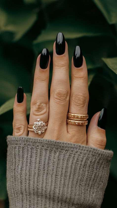 Elevate your style with these classy almond-shaped black nails, an embodiment of sophistication and modern flair. The sleek design offers a polished finish that complements any outfit, making them perfect for a chic evening out or a refined daytime look. Embrace the allure of simplicity and let your nails make a statement of elegant confidence. 💅🌟 Bridesmaid Black Nails, Plain Black Almond Nails, Matte Black Nails Almond, Classy Black Nail Designs, Dark Moody Nails, Almond Black Nails, Black And Chrome Nails, Black Nails Almond, Black Wedding Nails