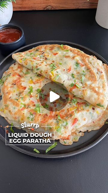 Slurrp App on Instagram: "LIQUID DOUGH EGG PARATHA

Try this very simple and easy to make paratha that requires no - kneading, no rolling and turns out super soft and extremely flavourful. Recipe shared by #slurrpcommunity member @homechefalison

Ingredients:
All purpose Flour - 1 cup 
Eggs - 3 whole 
Onions- 1 small
Ginger - 1/2 inch
Green chillies - 1
Capsicum - 1/2 
Red bell pepper - 1/2
Yellow bell pepper - 1/2
Fresh Coriander - 2 tbsp
Chilli Flakes - 1 tsp
Salt as per taste 
Oil as needed to fry parathas 
 
Follow @slurrpapp for exciting #recipeideas everyday!
.
.
.
.
.
.
.
.
.
.
.
.
.
.
.
.
.
.
.
.
.
.
.
.
.
.
.
#cookwithslurrp #eggparatha #liquidparatha #paratharecipe #quickrecipe #easyrecipe #viralrecipe #trending #paratha #vegrecipe #e Liquid Dough, Egg Paratha, Yellow Bell Pepper, Paratha Recipes, All Purpose Flour, Chilli Flakes, Veg Recipes, Red Bell Pepper, Bell Pepper