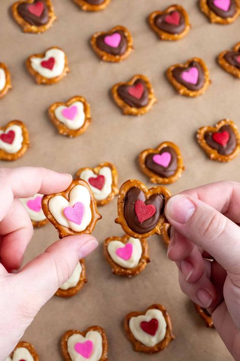 Chocolate Heart Pretzels Are The Perfect Sweet and Salty Valentine Treat Pretzel Hearts Valentine Treats, Pretzel Chocolate Hearts, Valentine Chocolate Pretzels, Heart Shaped Pretzels, Valentine Pretzel Treats, Easy Valentines Day Snacks, Pretzel Valentines, Valentine's Pretzels, Pretzel Chocolate Treats