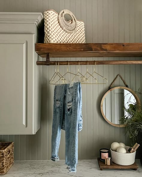 See what magic a little paint can do? This laundry room began as nothing remarkable, but through the simple acts of removing a few cabinets and introducing beadboard, a hanging rod, charming hardware, and wall-to-wall countertops, it’s a whole new room. Not only is it visually transformed, but it’s now exponentially more practical as well. ✨ • • • #interiordesign #endlesspossibilities #designforeveryone #interiors #midwestdesigner #AKDesignStudio #akdsjadestoneplace #laundryroommskeover Diy Laundry Room Mud Room, Wood Wall In Laundry Room, Coat Rack In Laundry Room, Laundry Room Upper Cabinets With Rod, Cozy Farmhouse Laundry Room, Laundry Room Ideas With Beadboard, Laundry Room With Rod Hanging Clothes, French Door Laundry Room, Bead Board Pantry Walls