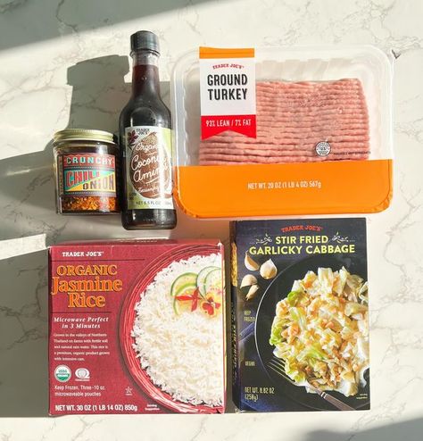 Anna Lisa | Trader Joes 5 Items or Less Recipes on Instagram: "Make this easy and healthy 5 Ingredient Trader Joe’s meal done in 20 min! Serves 3-4 Ingredients Ground turkey 1/4 cup Coconut Aminos 1 package Garlicky Cabbage Frozen Jasmine rice Crunchy chili onion Garnish w green onion (optional) Cook the ground turkey for 10 min, then add 1/4 cup coconut aminos and cook for 5 min longer while you microwave the garlicky cabbage. Then stir in the cabbage and heat for 1-2 minutes together. Serve over the Jasmine rice, add desired amount of crunchy chili onion, top w some sliced green onions and enjoy! Tag a friend who should try this easy meal! #traderjoes5itemsorless #traderjoesmeals #traderjoesideas #traderjoeshoes #traderjoesislife #traderjoesfood #traderjoeslife #traderjoesobsessed Trader Joe’s Stir Fry, Trader Joe’s Garlicky Cabbage, Trader Joe’s 5 Items Or Less, Trader Joes Chili Onion Crunch Recipes, Crunchy Chili Onion Trader Joes Recipes, Trader Joe’s Lunch Ideas, Trader Joe’s Recipes, Garlicky Cabbage, Trader Joe’s Meals