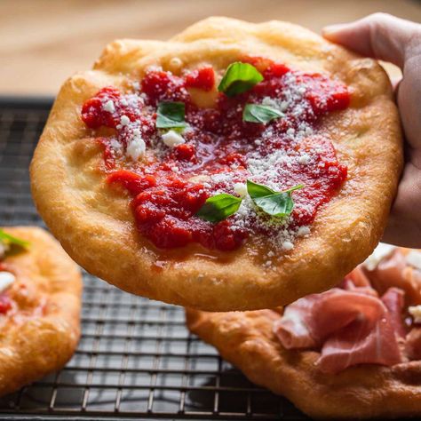 Pizza fritta, also known as pizzette fritte, is pizza dough that's fried until golden and topped with a variety of toppings such as marinara, mozzarella, and basil, prosciutto and mozzarella, or powdered sugar for a sweet treat! #pizzafritta #pizzettefritte #friedpizzadough Pizza Fritte, Fried Pizza Dough, Prosciutto And Mozzarella, Fried Pizza, Sip And Feast, Italian Main Dishes, Store Bought Pizza Dough, Savory Tarts, Idea Business