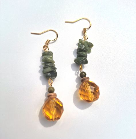 Earthy bohemian style gemstone gold dangle earrings; crafted with green serpentine stone chips, 4 mm polished unakite stone, natural coconut shell heishi beading, and a beautiful amber colored Czech glass beading.  Click on the link below if you would like to see more artisan jewelry and unique artwork! https://www.etsy.com/shop/CailinCreatesCo Cottagecore Earrings, Earthy Bohemian, Serpentine Stone, Artisan Jewelry Earrings, Earthy Jewelry, Nature Earrings, Stone Chips, Gold Dangle Earrings, Witchy Jewelry