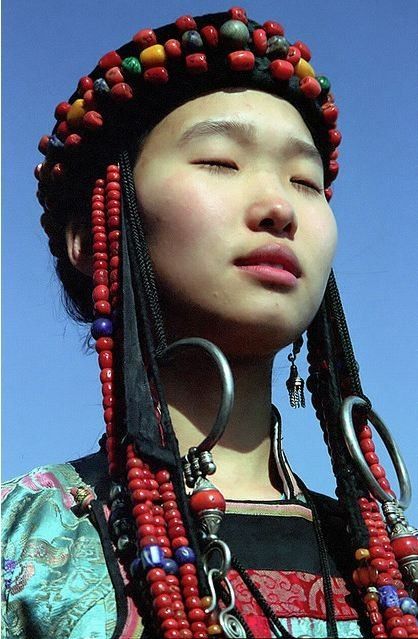 A Buryat girl from the Buryatia Republic, Russia. The Buryat people are descended from various Siberian and Mongolic peoples that inhabited the Lake Baikal Region. Then in the 13th century the Mongolians came up and subjugated the various Buryat tribes (Bulgachin, Heremchin). The name "Buriyad" is mentioned as one of the forest people for the first time in The Secret History of the Mongols (possibly 1240). . Ancient Character, Lake Baikal, Indian Salwar Kameez, People Of The World, World Cultures, Interesting Faces, 인물 사진, Traditional Dress, Mongolia