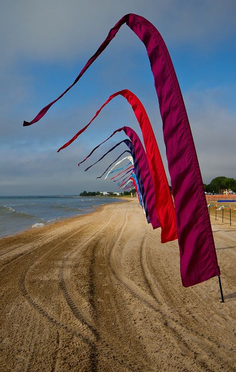 This wind art is just solid color rippling in the off-shore breeze. The height and subtle curvature give the display some presence though. T.P. (my-best-kite.com) "Beautiful Beach Banners" Cropped from a photo by Lester Public Library on Flickr. Two Rivers Wisconsin, Wind Flag, Beach Flags, Wind Art, Kite Festival, Marina Beach, Wind Sculptures, Beach Events, Beach Festival