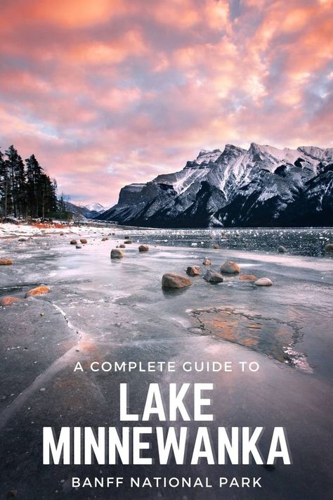 A sunset at Lake Minnnewanka that has been frozen over in winter with the mountains towering in the background. Minnewanka Lake, Canadian Rockies, Banff National Park, Vacation Places, Canada Travel, Rocky Mountains, British Columbia, Cool Places To Visit, National Park