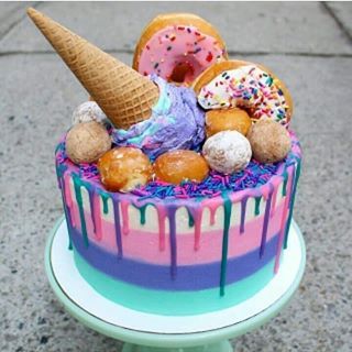 🌟💜 How vibrant is this ice cream cone cake topped with actual donuts? 😻 I found this on @thosesweetdays - they share gorgeous cakes so check them out! 🍦🍩🍰🍨🍭🍧 - Visit www.donutexplorers.com for more!  -  -  -  -  #cakes #cake #icecream #icecreamcake #icecreamcone #icecreamconecake #icecreamlover #icecreamcakes #icecreamday #stripedcake #buttercream #buttercreamcake #dripcake #dripcakes #cakesofig #cakesofinsta #summerfood #summercake #summervibes☀️ #donut #doughnut #doughnuts #donuts #su Ice Cream Cone Cake, Donut Ice Cream, Colorful Cake, Smash Cakes, Colorful Food, Simple Birthday Cake, Easy Cake Decorating, Crazy Cakes, Decorated Cakes