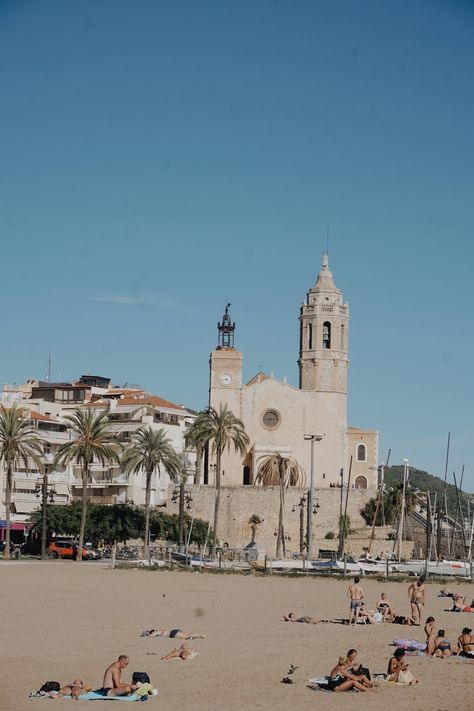 Pictures What to do in Sitges Spain Photography Travel, Sitges Church Sant Bartomeu i Santa Tecla & beachgoers. Sitges Spain Aesthetic, Travel Wallpaper Travel Wallpaper Aesthetic, Spain Aesthetics, Sitges Spain, Childhood Summer, Spain Beach, Backpacking Spain, Barcelona Beach, Barcelona Spain Travel