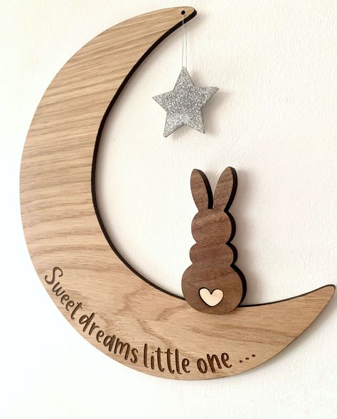 If you are looking for a unique and special piece of decor for your baby's nursery, then look no further. This moon, with it's cute wooden bunny is a beautiful addition to any baby's room, as it's neutral wooden tones and engraved message fit perfectly with any nursery decor. The moon is made from an oak veneered wood and the bunny sits on top in a darker walnut. It has a cute little heart tail, which is cut from lighter wood and inserted into the walnut for a high quality finish. The star which Wooden Decor Pieces, Nursery Wood Decor, Wooden Moon Wall Decor, Baby Laser Cut Ideas, Wooden Nursery Decor, Cnc Wood Design, Wood Laser Engraving Ideas, Wood Laser Cut Ideas, Wood Nursery Decor