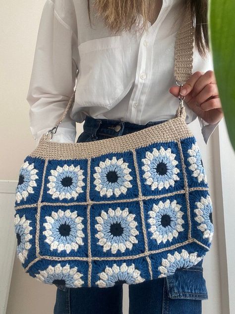 Crochet Boho Bag with Evil Eye

This large crochet tote bag features a beautiful granny square design and a sparkling evil eye charm. It's the perfect bag for carrying your everyday essentials with a touch of bohemian Evil Eye Crochet Bag, Evil Eye Crochet, Evil Eye Bag, Crochet Bag Granny Square, Crochet Bag Granny, Eye Crochet, Granny Square Tote, Crochet Boho Bag, Crocheted Bags