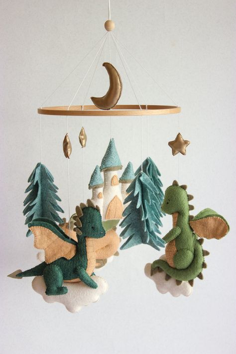 Dragon baby mobile with 3 dragons, castle,  fir trees, stars and moon is perfect for a nursery. Your baby will love it! This baby mobile is very modern and will be a wonderful gift for baby shower, expecting mom and newborn! 🐉 MATERIALS Every toys is 100% quality handmade. This mobile is absolutely eco-friendly and safe for baby. It is made from premium felt, hand cut and sewn with embroidery threads. I do each seam with my own hands! I don't use a sewing machine. All materials are hypoallergen Harry Potter Baby Room Themed Nursery, Story Book Nursery Theme, Lord Of The Rings Themed Nursery, Knights And Dragons Nursery Baby Boy, Baby Room Forest Theme, Acotar Nursery, Baby Shower Dragon Theme, Dragon Nursery Boy, Land Before Time Nursery