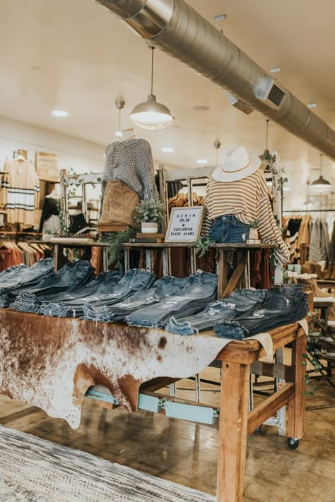 Wooden Spool Retail Display, Boutique Jeans Display, Clothing Displays Ideas, Boutique Denim Display, Retail Jean Display, Display Jeans Ideas, Western Storefront Ideas, Boot Store Display, How To Display Jeans In A Boutique